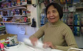Anh Vo: Assists customers at Maria's Market on Dorchester Ave., one of many convenience stores with a high volume of SNAP purchases. Photo by Steve Kurkjian